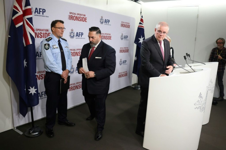 Anthony Russo (C), the FBI's legal attachÃ© to the US embassy in Canberra, leaves the podium after speaking to media as Australia's Prime Minister Scott Morrison (R) and Australian Federal Police Commissioner Reece Kershaw (L)