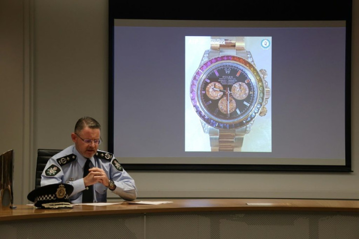 Australian police show a slide displying a seized gold and gemstone-studded Rolex watch, valued at $295,000