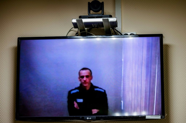 Jailed Kremlin critic Alexei Navalny appears on screen via a video link from prison during a court hearing on May 26