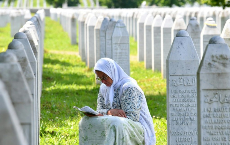 A Bosnian Muslim woman in the Srebrenica Memorial Cemetery in Bosnia on Tuesday, among grave stones of her relatives who were among the victims of the 1995 massacre