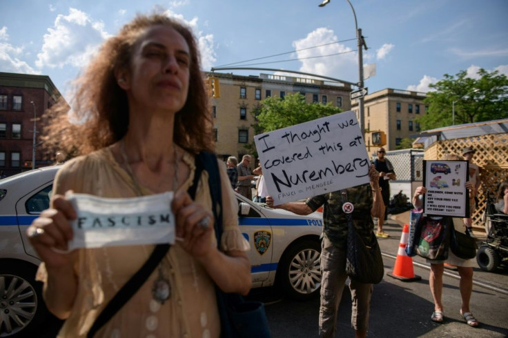 Anti-vaccination activists shout slogans and hold placards as First Lady Dr Jill Biden and top US scientist Anthony Fauci visit the Abyssinian Baptist Church Covid-19 vaccination clinic in Harlem on June 6, 2021.