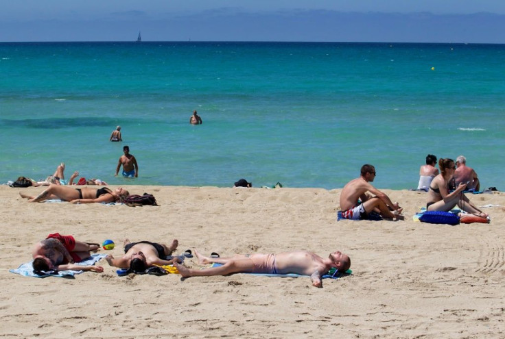 Tourists sunbathe at Palma Beach in Palma de Mallorca after Spain opens its borders to vaccinated travelers from all over the world
