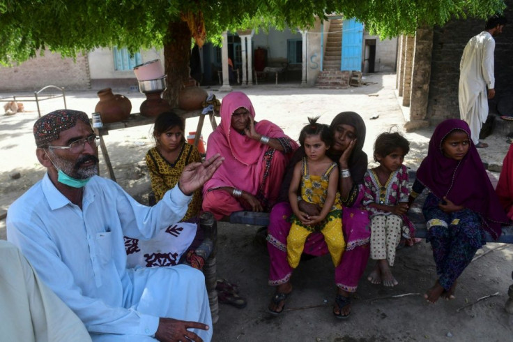 Ali Nawaz (L) and his family were jolted awake by the sound of express trains colliding just a few hundred metres from their home