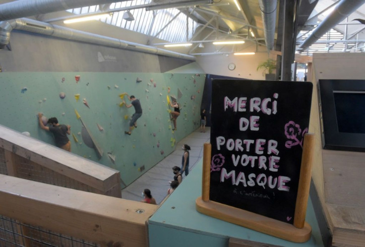 Fitness buffs were happy to finally be allowed inside again, such as at this climbing club, where a sign reads 'please wear your mask'