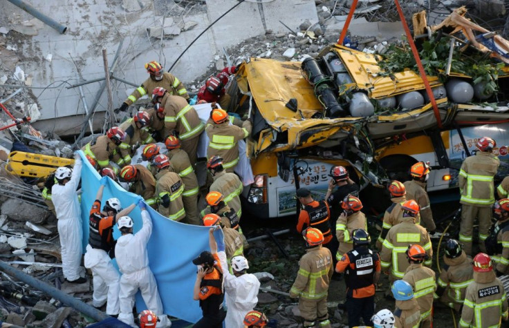 South Korean rescue workers search for survivors in the debris of a collapsed building in Gwangju
