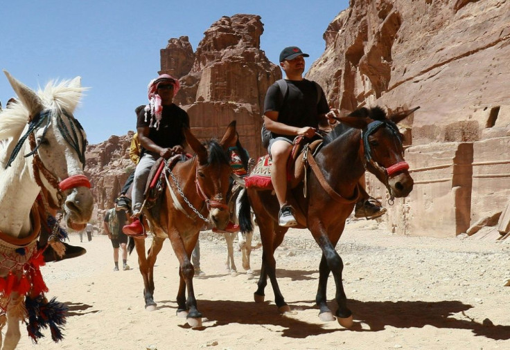 Tourists ride donkeys and horses as they visit Jordan's ancient city of Petra after it reopened following restrictions to stem the coronavirus pandemic