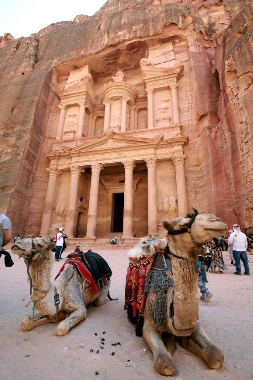 Camels sit in front of the Treasury, in Jordan's ancient city of Petra, a UNESCO World Heritage site