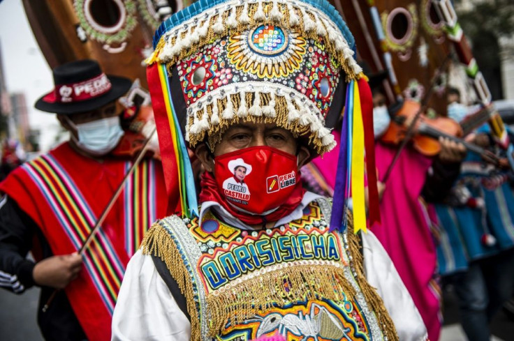 A supporter of leftist Pedro Castillo in colorful regional Andean attire joins the rally in dowtown Lima