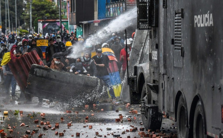 Police fire a water cannon at demonstrators in Bogota