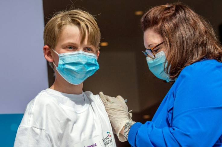 The United States began inoculating teens -- like 13-year-old Charles Muro in Connecticut -- with Pfizer-BioNTech's Covid-19 vaccine in May 2021, and Moderna is now the second firm to seek a US green light to administer its shot to adolescents