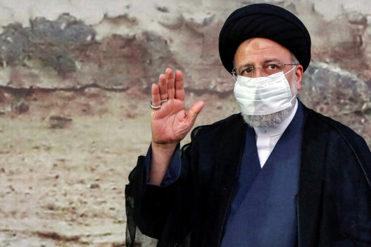 Iranian presidential candidate and frontrunner Ebrahim Raisi greets supporters at an election campaign rally in the city of Eslamshahr, south of Tehran