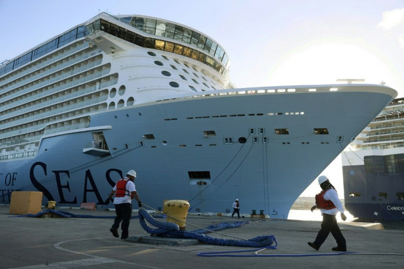 Dock workers tie the Royal Caribbeanâs Odyssey of the Seas to its berthing spot on June 10, 2021 in Fort Lauderdale, Florida