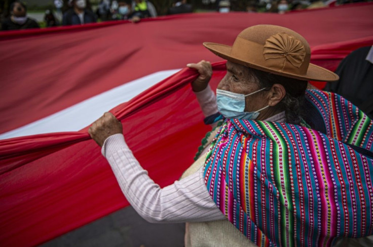 Rural supporters of Pedro Castillo march outside Peru's national election office in a show of support for their presidential candidate