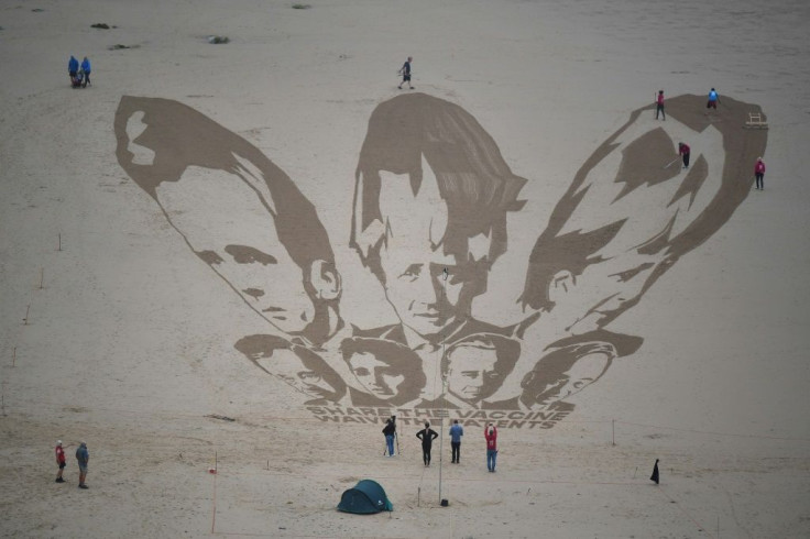A sand drawing of the G7 leaders in Cornwall by activists who called on nations to 'share the vaccine and waive the patents'