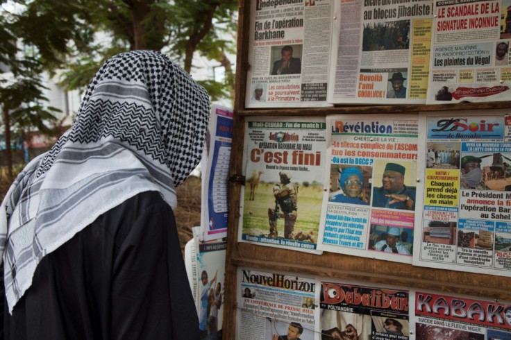A man looks at news headlines announcing a major drawdown of France's military presence in the Sahel, where forces have been battling jihadist insurgents for nearly a decade, in Bamako on June 11, 2021.French President announced on June 10, 2021 that the 