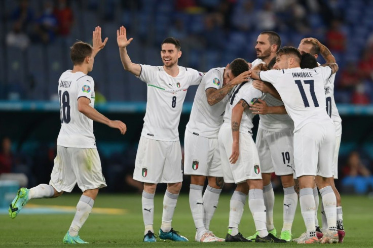 Italy's players celebrate after Merih Demiral's own goal put them in front against Turkey