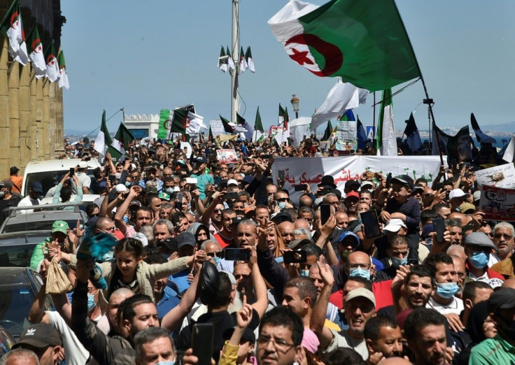 Algerian security forces have deployed in large numbers to ensure polls pass off peacefully, hoping to block anti-government activists, such as these people pictured during a demonstration in the capital Algiers on May 7