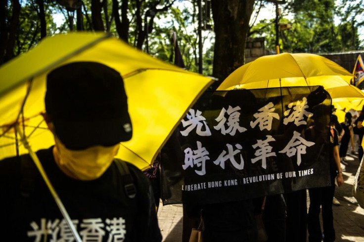 Pro-democracy activists held flags reading "liberate Hong Kong, revolution of our times" during a rally in Tokyo's Shinjuku district