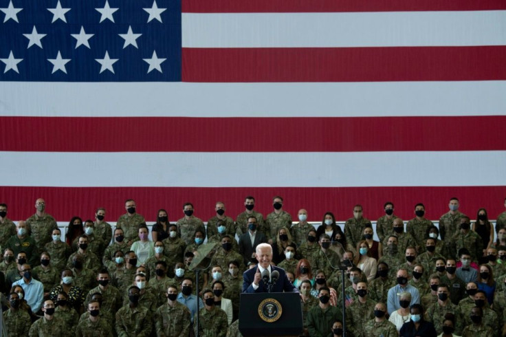 'Please, at ease,' Biden told US service personnel upon his arrival in England. 'I keep forgetting I'm president.'