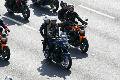 Brazilian President Jair Bolsonaro gestures to supporters as he leads a motorcycle rally in Sao Paulo on June 12, 2021