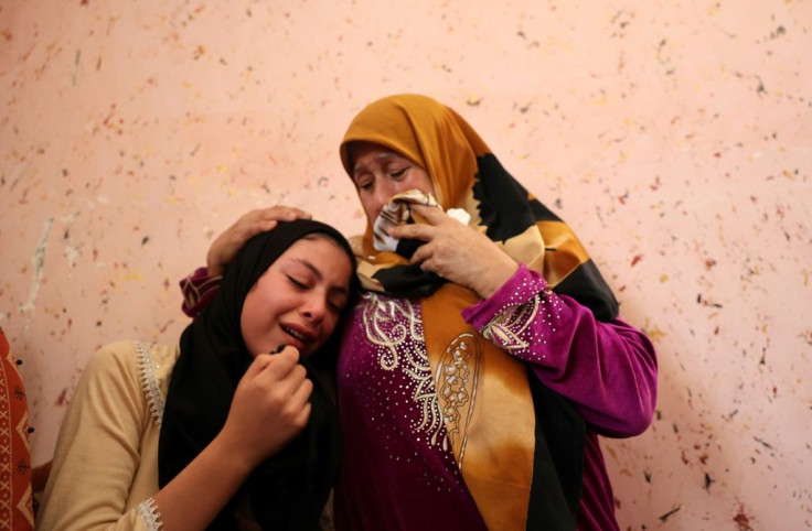 Relatives of Dima Assalia, 11, cry during her funeral following an Israeli air strike in Jabalia in the northern Gaza Strip on May 20