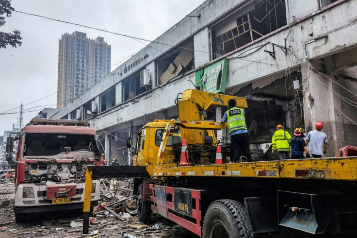 Workers search for victims in a building damaged by a gas line explosion in the Chinese city of Shiyan