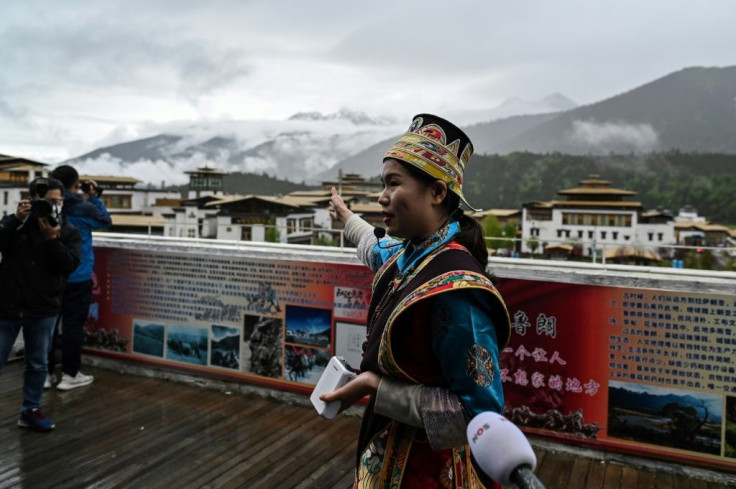 A guide speaks to the media during a government-organised media tour in the town of Lunang in Tibet