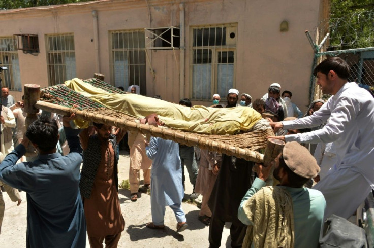 Relatives carry the body of a polio worker who was shot dead by gunmen in a string of targeted attacks on vaccinators in Afghanistan