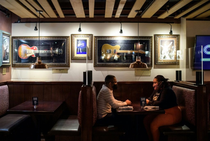 A couple dines indoors at the Hard Rock Cafe in New York City, which reopened in May after being closed for more than a year