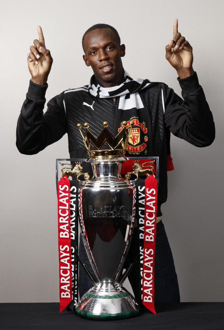 Usain Bolt poses with the Premier League trophy in Manchester in 2009.