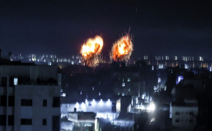 Explosions light up the night sky over Gaza City as Israeli forces shell the Palestinian enclave