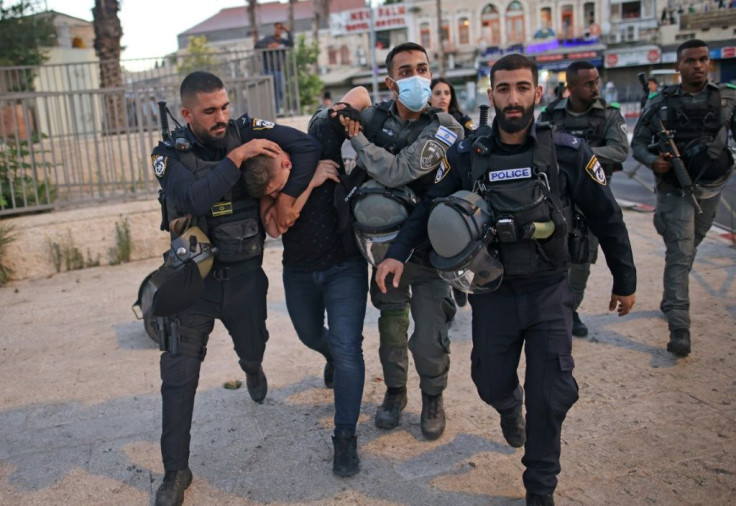Israeli police detain a Palestinian near Damascus Gate to clear the route of a controversial march into annexed east Jerusalem by Jewish ultranationalists