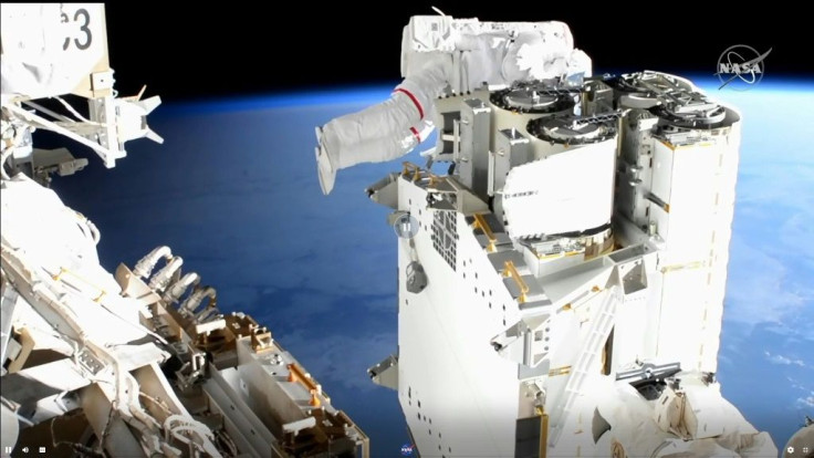 European Space Agency astronaut Thomas Pesquet(R) checks cables in order to install new solar arrays on June 16, 2021