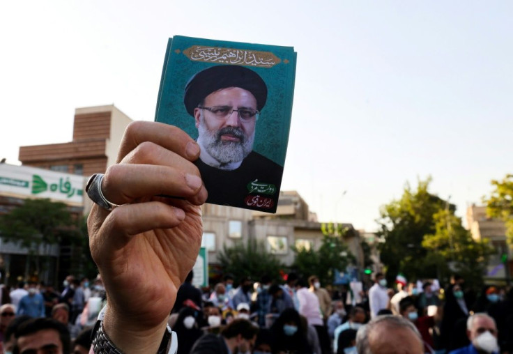 A supporter holds up a photograph of ultraconservative cleric Ebrahim Raisi, the favourite to win Friday's Iranian presidential election, at a rally in Tehran on the final day of the campaign