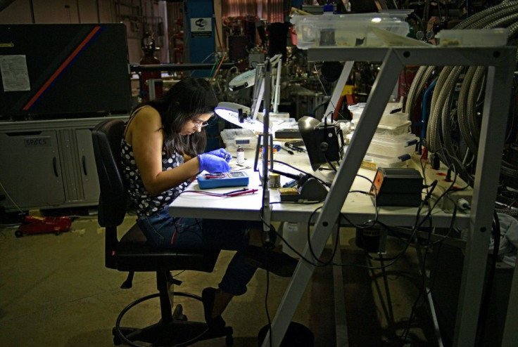 A woman works on the contacts of a super conductor related to a particle UVX second-generation accelerator in Sao Paulo, Brazil, on September 13, 2019