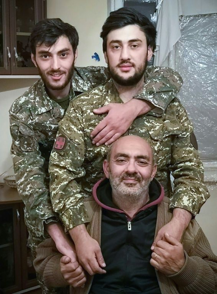 Veterans: Artyom Muradyan, left, by his brother Serzh and their father Marat, seated