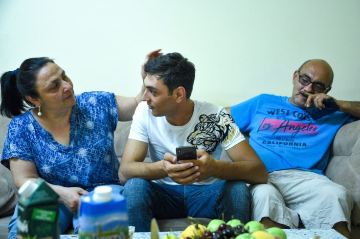 Artyom Muradyan, centre, with his parents in Yerevan. Pashinyan 'could not deliver on (his) promises and he gave away our lands,' the former soldier said