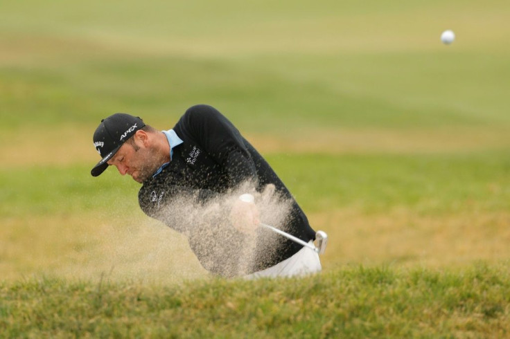 Spain's Jon Rahm blasts out of a bunker during Friday's second round of the US Open at Torrey Pines, where the world number three grinded out a one-under par 70