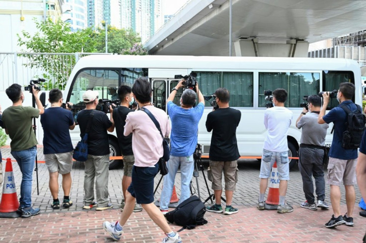 A van believed to be carrying the two executives arrives at court