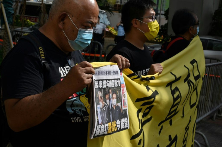 Supporters of the two Apple Daily executives protest outside Saturday's court hearing