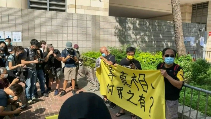 IMAGES Supporters gather as two executives from Hong Kong's pro-democracy Apple Daily are to appear at court charged with collusion after authorities deployed a sweeping security law to target the newspaper, a scathing critic of Beijing.Chief editor Rya