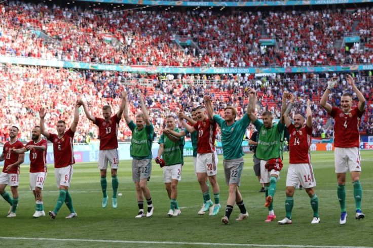 Hungary's players celebrate with their fans after holding France to a draw in Budapest