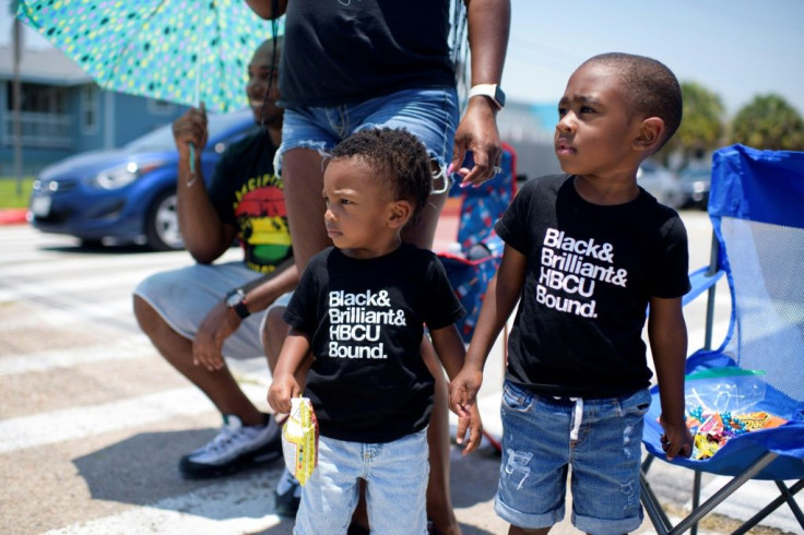 Two boys and their family celebrate during a Juneteenth parade in Galveston, Texas, on June 19, 2021