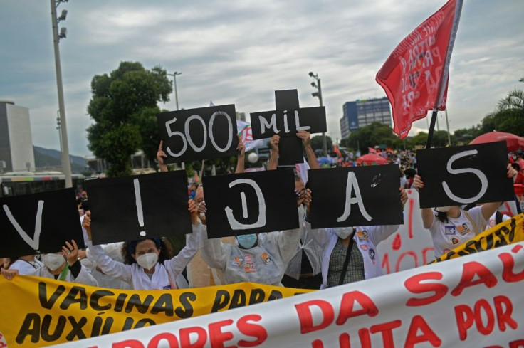 Demonstrators hold a sign reading '500 thousand lives' during a protest June 19, 2021 in Rio de Janeiro against President Jair Bolsonaro, who is widely blamed for not taking the Covid-19 pandemic more seriously