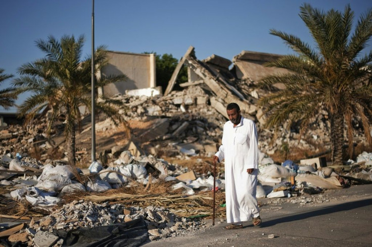 A man walks past a destroyed building at Libyan dictator Moamer Kadhafi's former headquarters in Tripoli in a picture taken in 2012, one year after the ruler was ousted and killed in a NATO-backed uprising