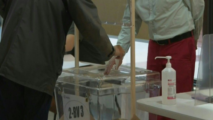 Voters arrive at a polling station in the 2nd arrondissement of Paris as some 48 million French people are called to the polls for the first round of regional and departmental elections.