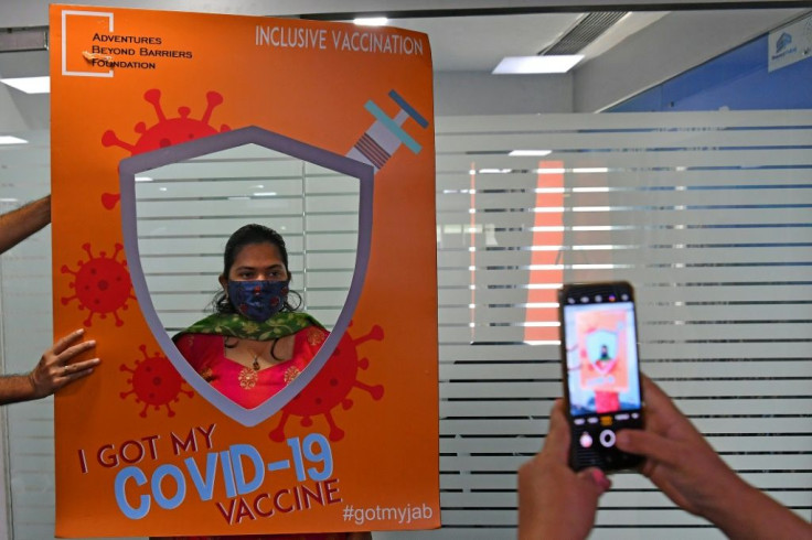 A woman has her photograph taken after getting inoculated in Mumbai