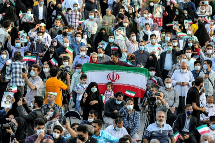 Supporters of Raisi gather during a rally celebrating his victory in Tehran's Imam Hussein square