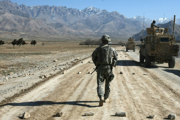 In this file photo a US soldier walks along a road under construction near  Kabul on January 11, 2010