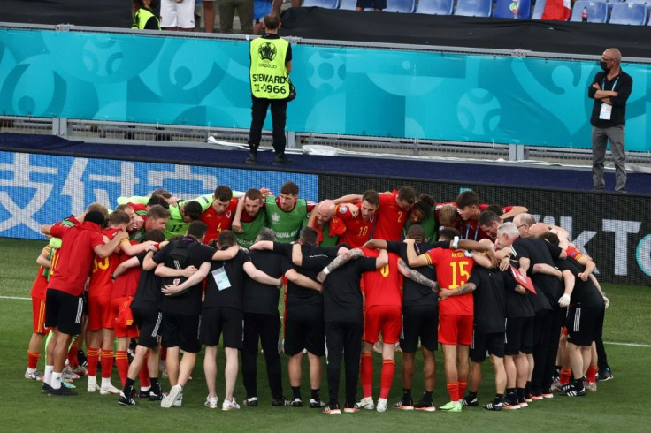 Wales players gather in a huddle after securing a place in the last 16 of Euro 2020 despite losing to Italy in Rome